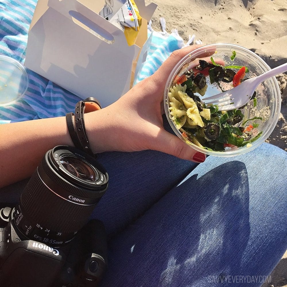 Eating 5th Avenue Deli lunch on the beach