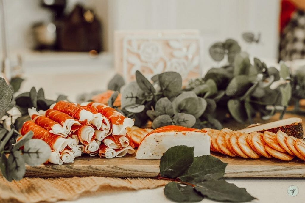 mother blessing meat and cheese tray