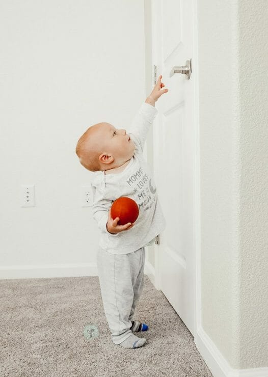 baby opening door in Carter's baby clothes