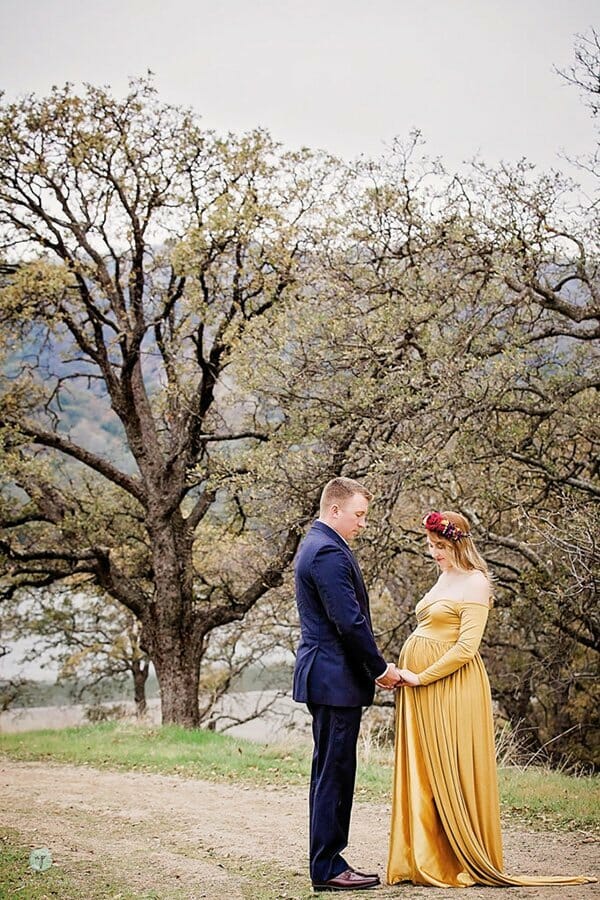 artistic couples maternity photo of holding hands