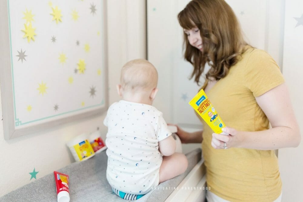 looking at baby on changing table_logo