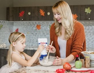 mother and daughter making Thanksgiving apple pie together