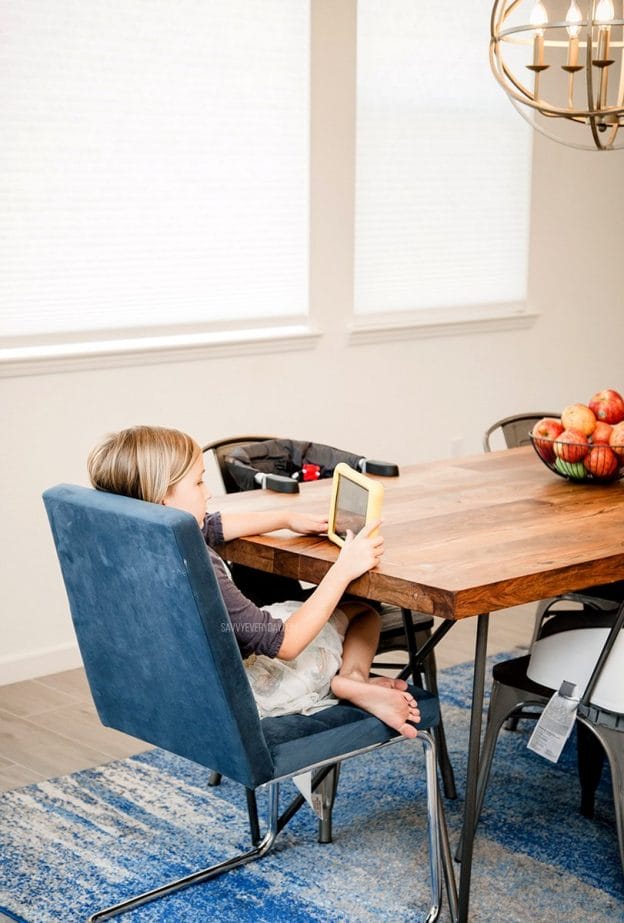 S sitting at table with kids tablet 