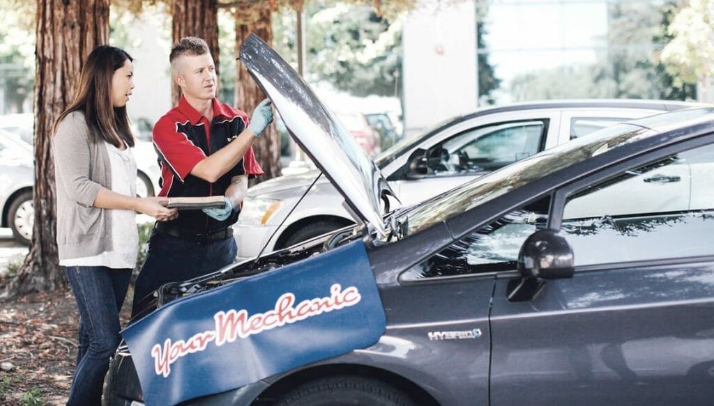 YourMechanic photo of mechanic at a car with woman